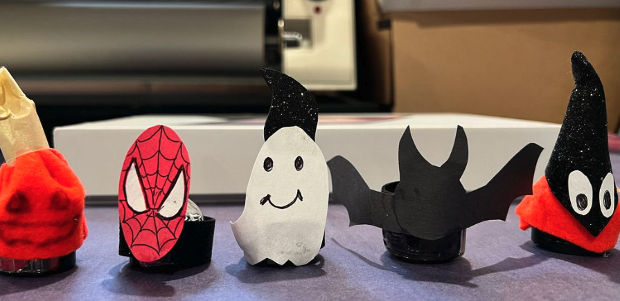 A picture of bots dressed up as ghosts, bats, and spiderman