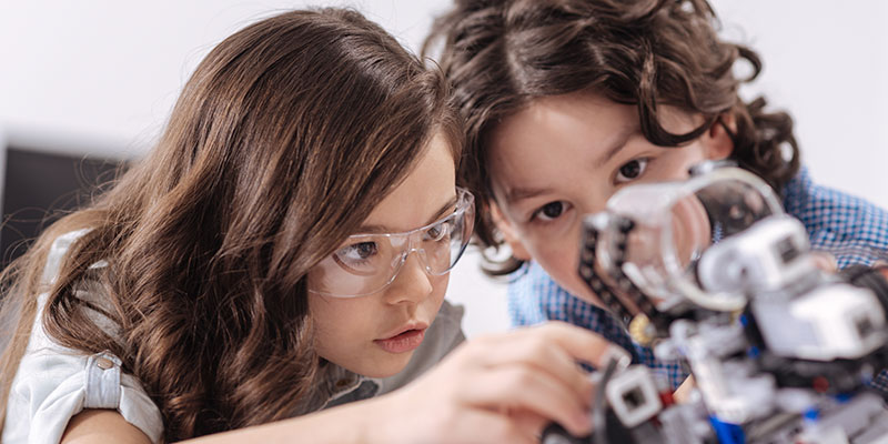 A girl and boy building a robot