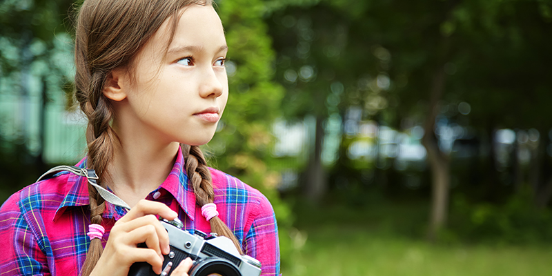 Young girl with a camera