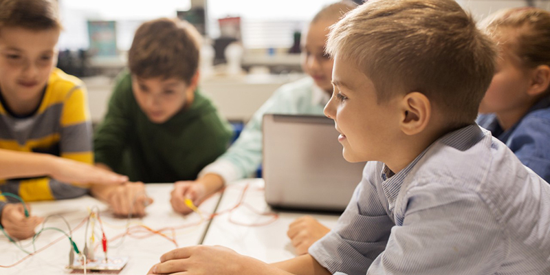 Students work with circuits in CS class