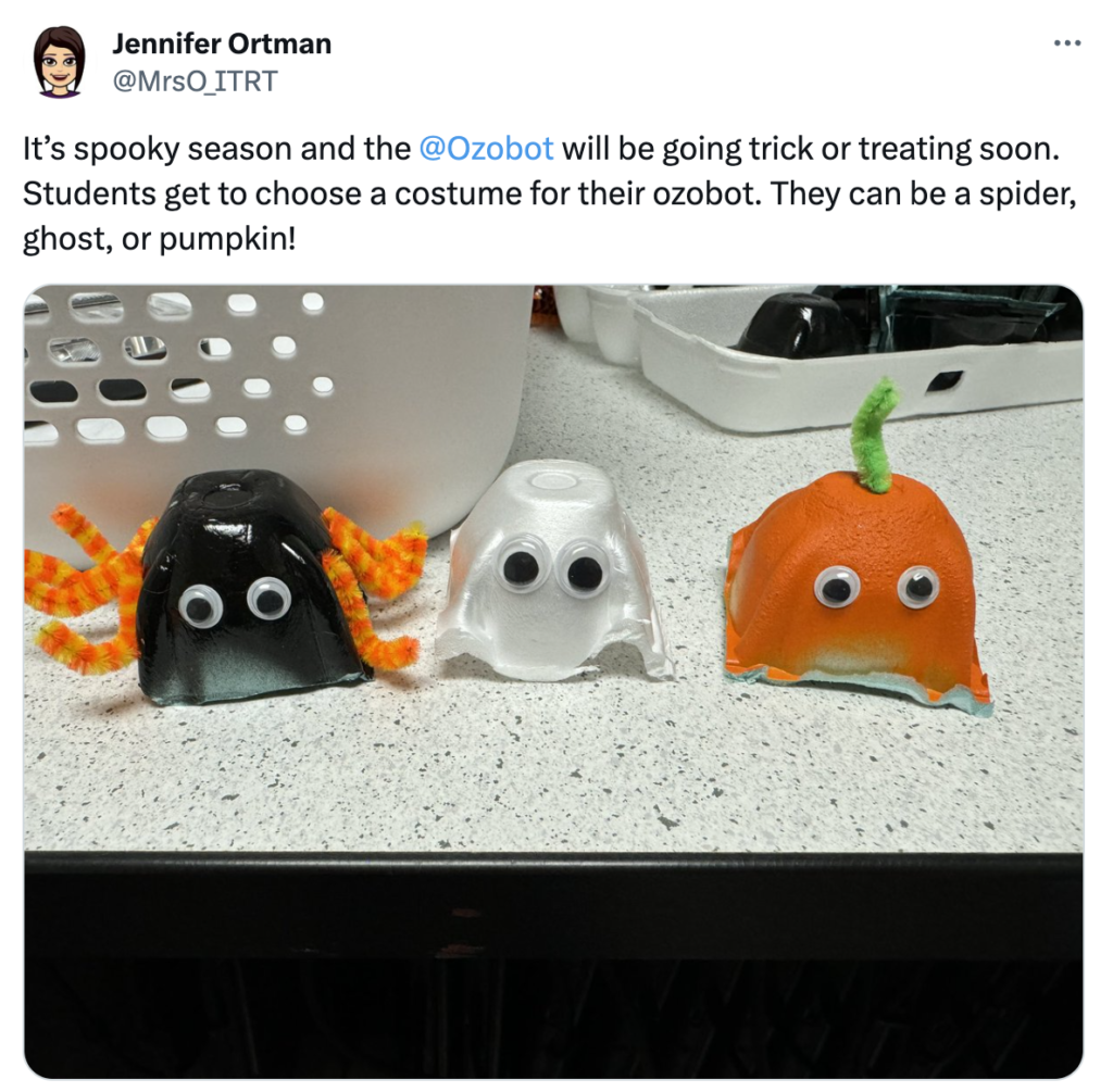 A picture showing Evo coding robots dressed up as a spider, ghost and pumpkin