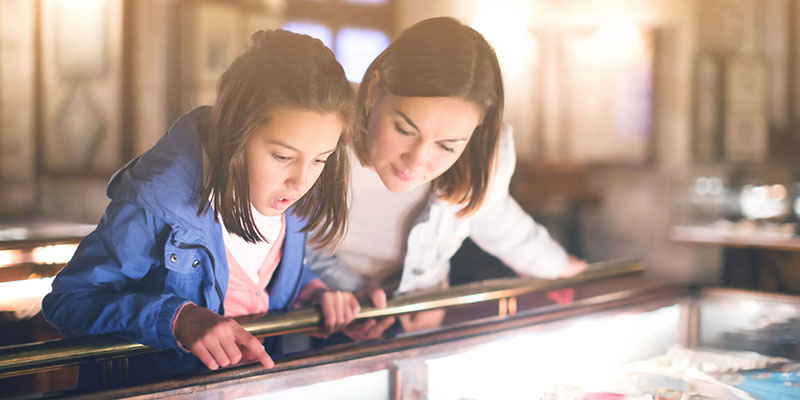 A mother and daughter inside a museum exhibition